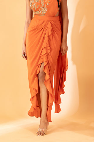 A rust pre-draped saree with hand embroidered blouse