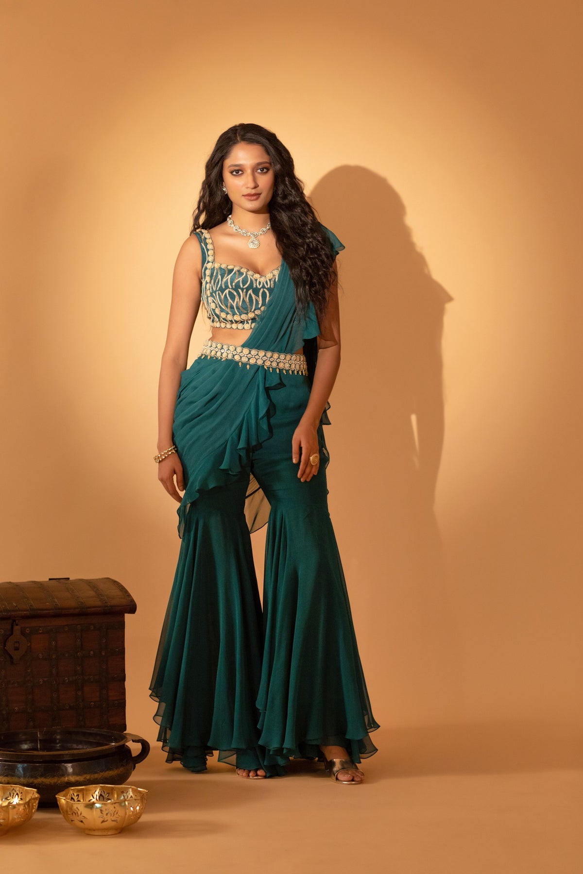 A pre-draped saree set paired with hand embroidered blouse and belt