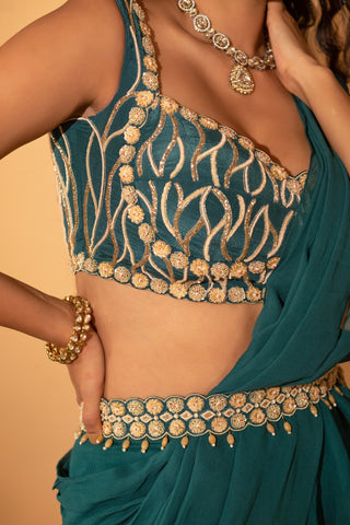 A pre-draped saree set paired with hand embroidered blouse and belt