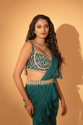 A pre-draped saree set paired with hand embroidered blouse and belt