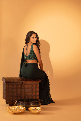 A bottle green saree set paired with embroidered blouse