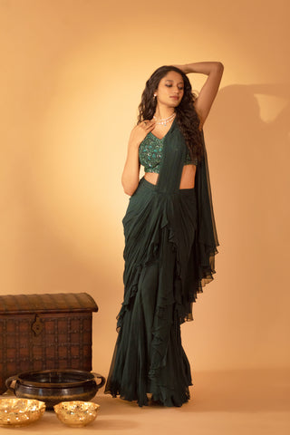 A bottle green saree set paired with embroidered blouse