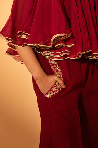 A jumpsuit with embroidered cape