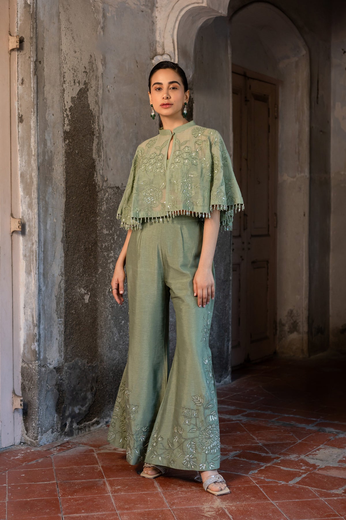 A pista green cape with side cut pant and bustier