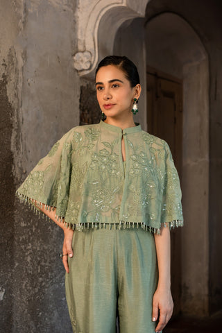 A pista green cape with side cut pant and bustier