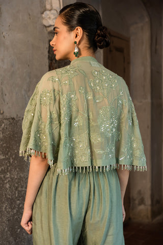 A pista green cape with side cut pant and bustier