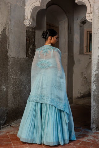 A pwder blue lehenga with maching blouse and cape