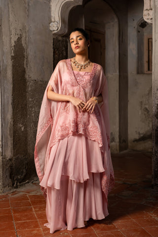 A baby pink jacket set paired with bustier and skirt