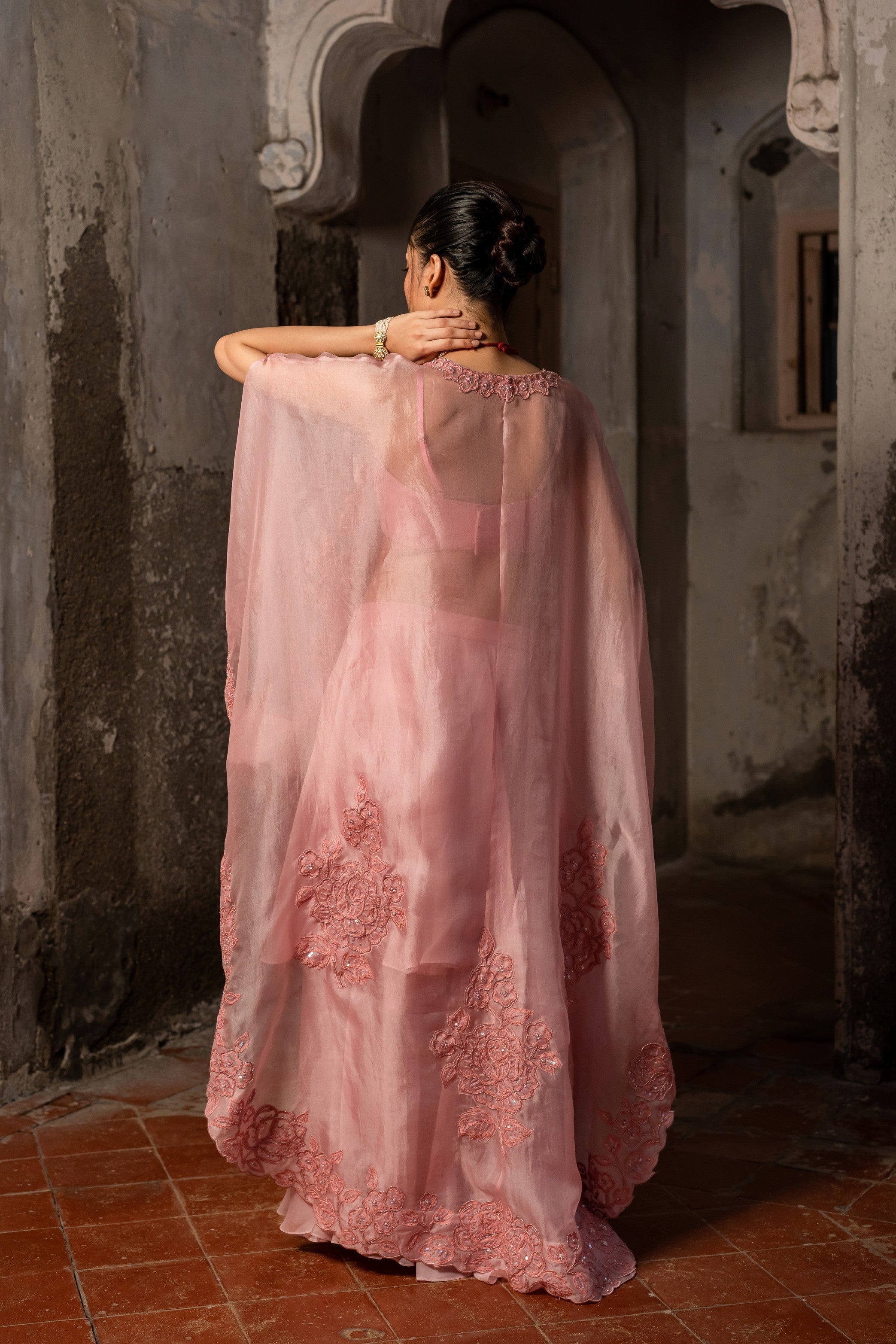 A baby pink jacket set paired with bustier and skirt