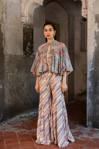 A jumpsuit paired with hand embroired cape