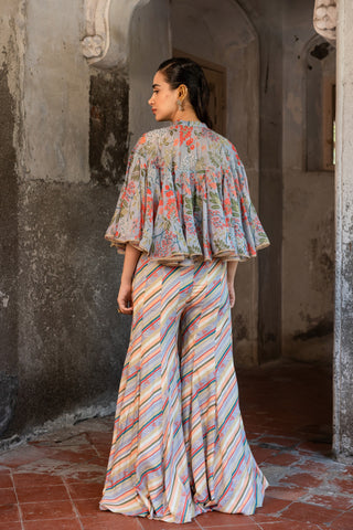 A jumpsuit paired with hand embroired cape