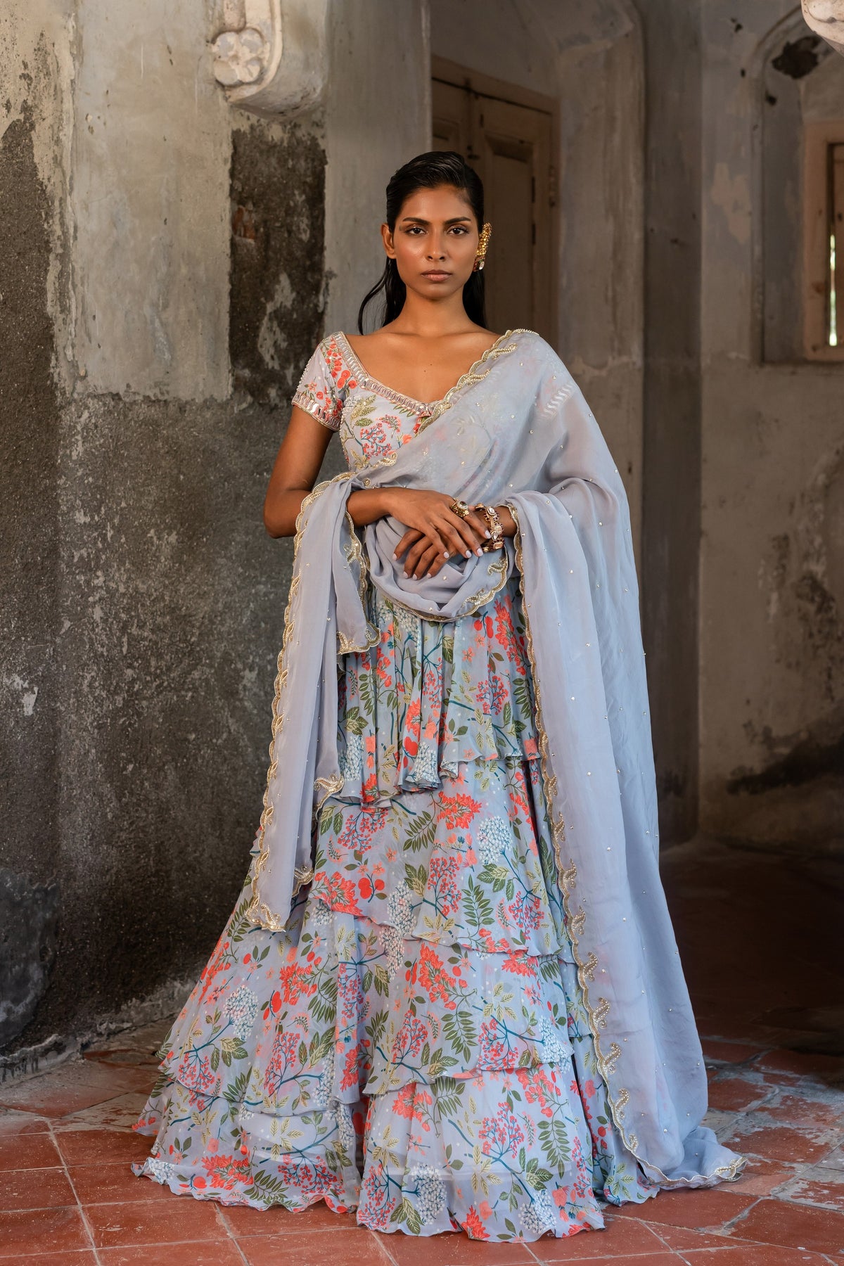 A printed embroidered layered lehenga set paired with blouse and duptta