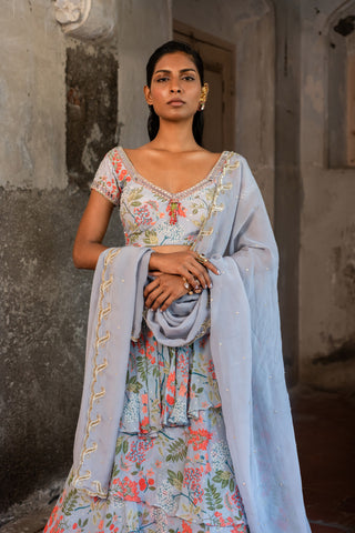 A printed embroidered layered lehenga set paired with blouse and duptta