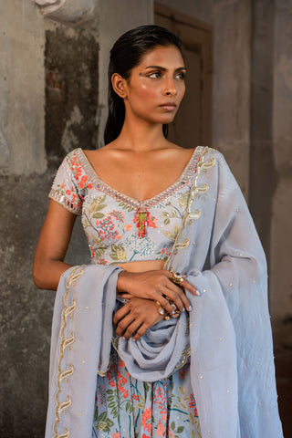 A printed embroidered layered lehenga set paired with blouse and duptta