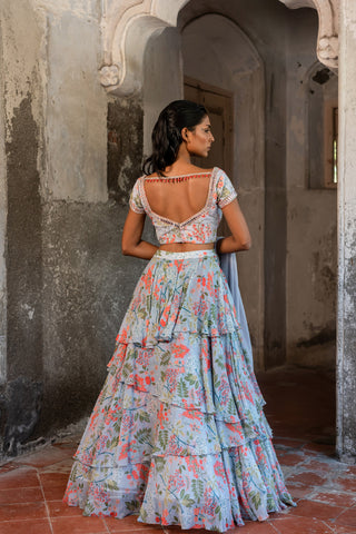 A printed embroidered layered lehenga set paired with blouse and duptta