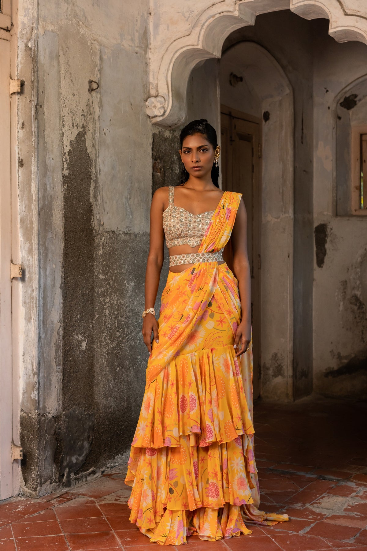 A pre-draped layer saree with hand embroidered blouse and belt