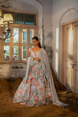 A printed embroidered layered lehenga set paired with blouse and duptta