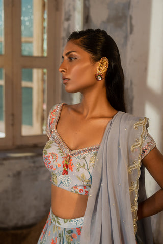 A printed embroidered layered lehenga set paired with blouse and duptta