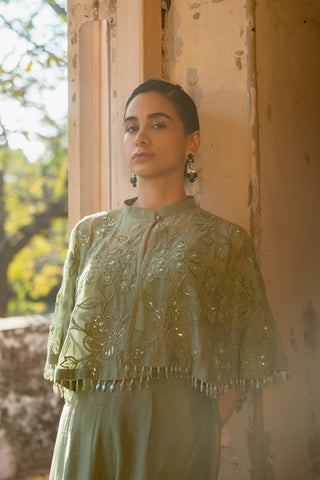 A pista green cape with side cut pant and bustier