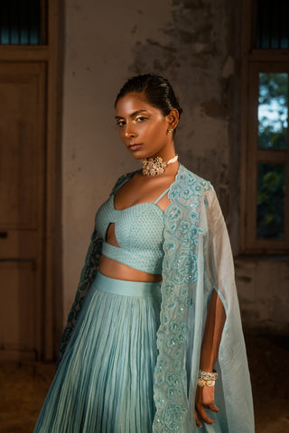 A pwder blue lehenga with maching blouse and cape