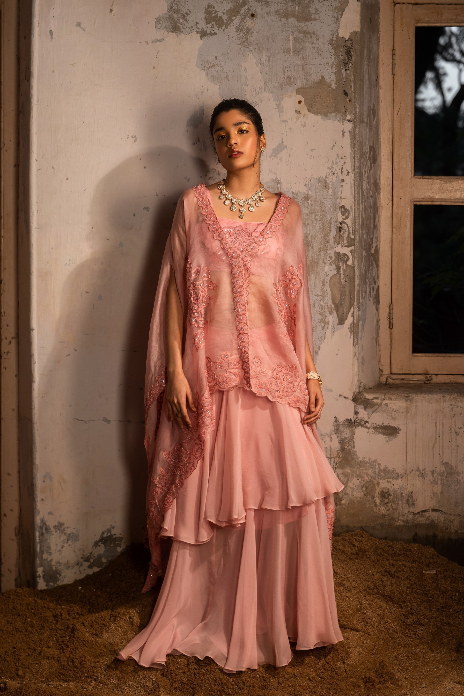 A baby pink jacket set paired with bustier and skirt