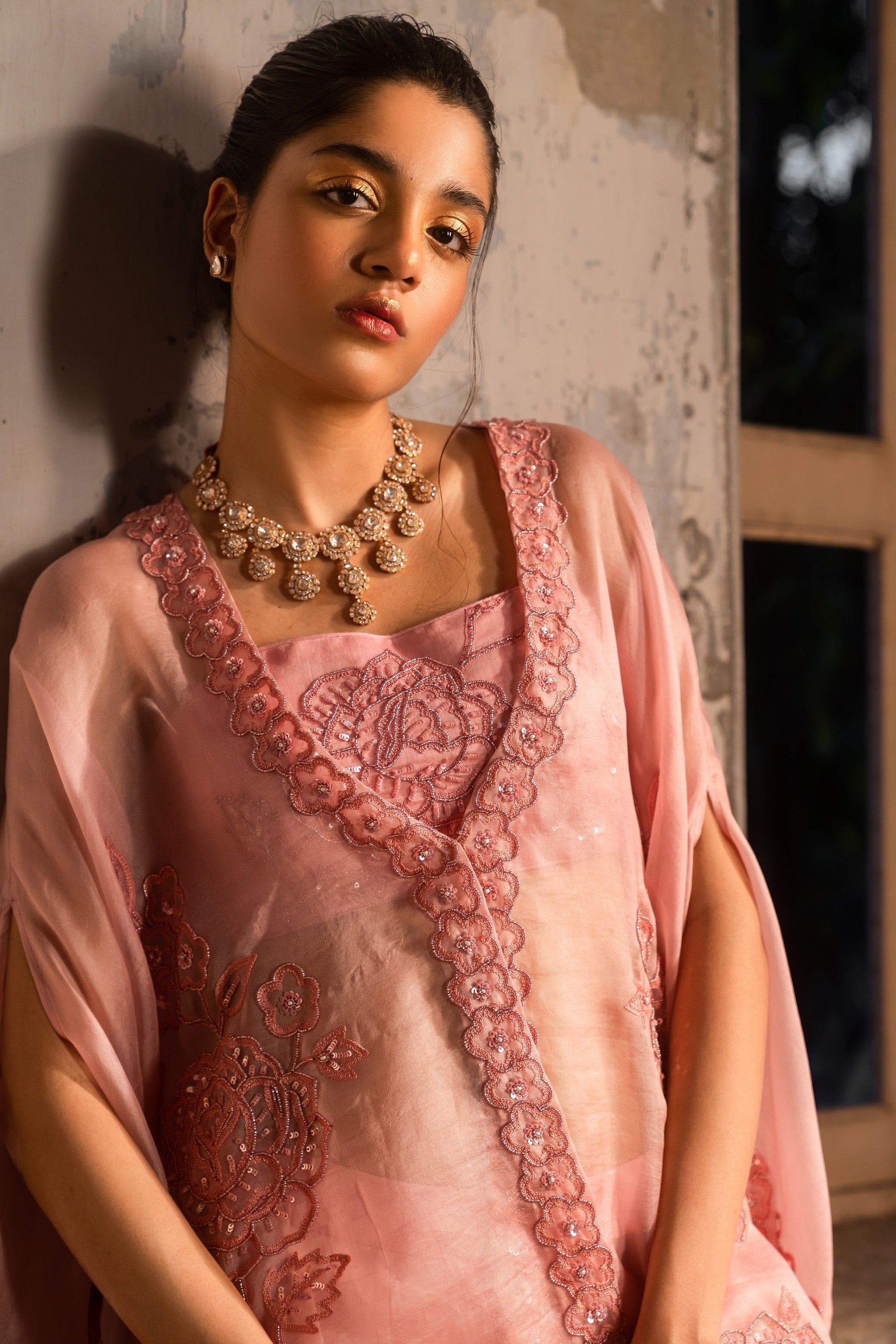 A baby pink jacket set paired with bustier and skirt