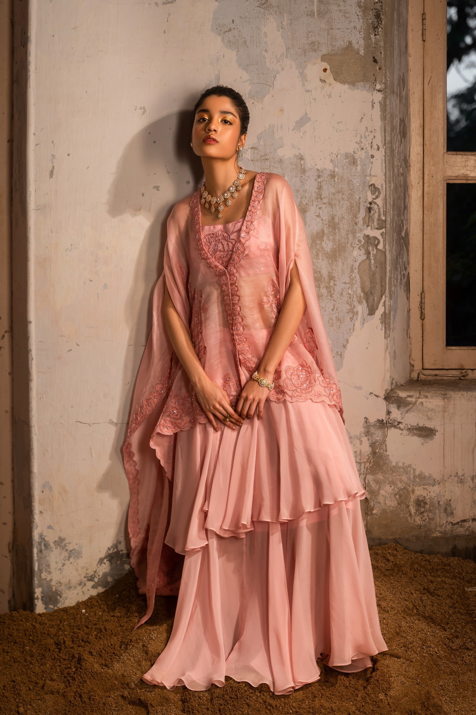 A baby pink jacket set paired with bustier and skirt