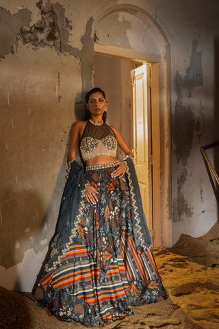 A printed teal blue lehenga with hand embroidered blouse and duptta